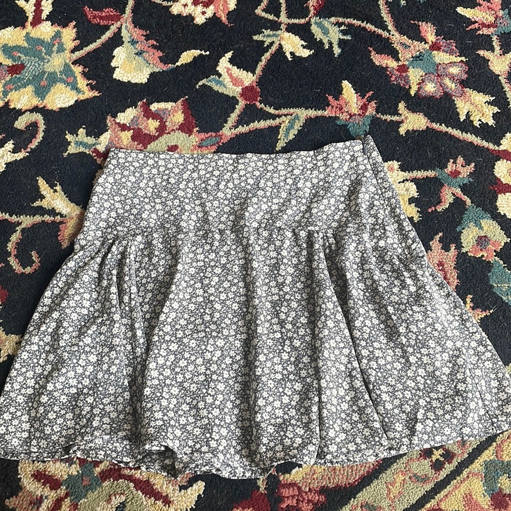 cute, short, and dusty grey-ish blue floral skirt, with small white flowers